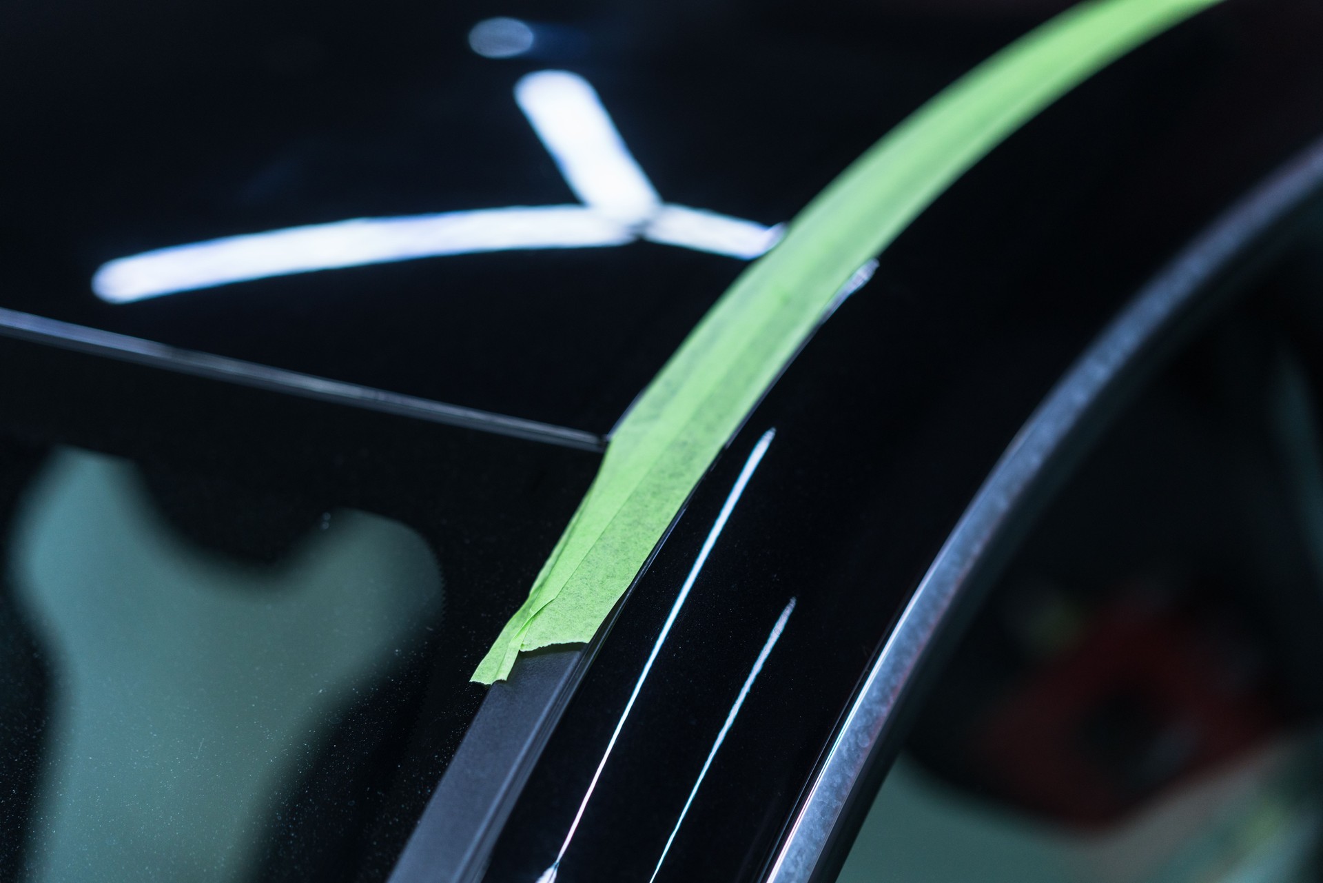 Sleek black Car prepared for polishing.Car detailing.